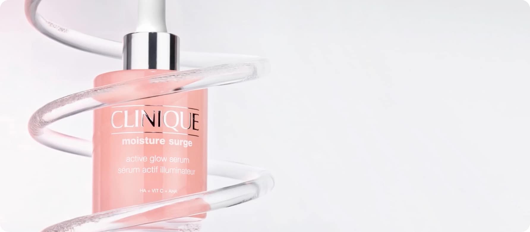 Close up of Moisture Surge Serum in front of animated lab glassware, in a brightly lit setting